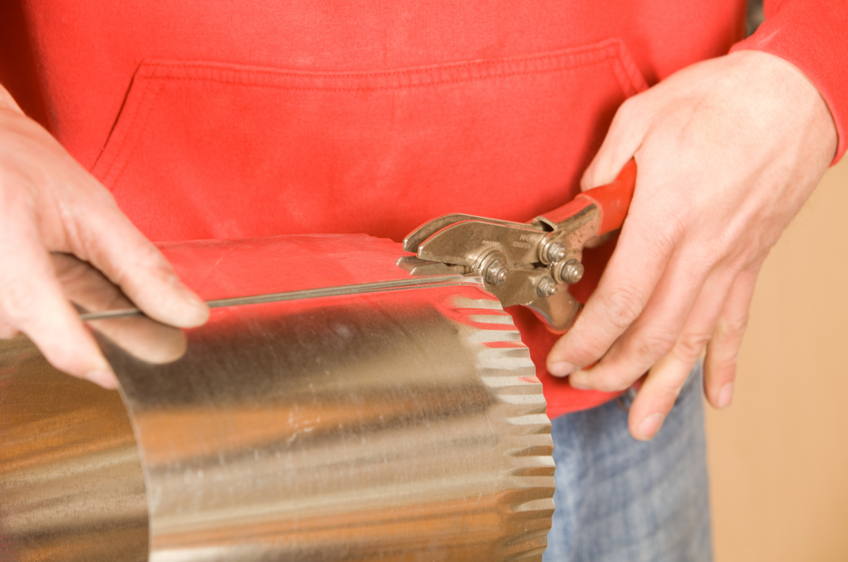 technician crimping ductwork