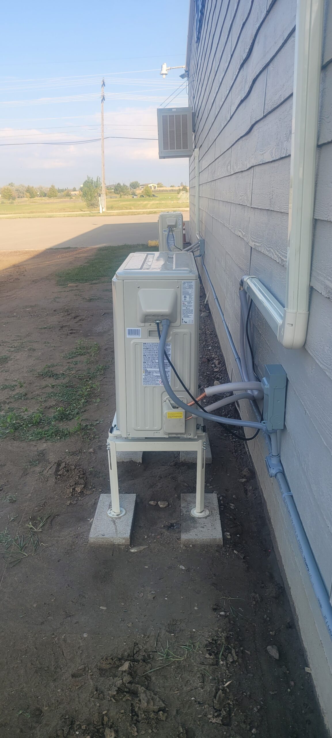 Two outdoor ductless heat pump units take up a small amount of space for the cooling they provide.