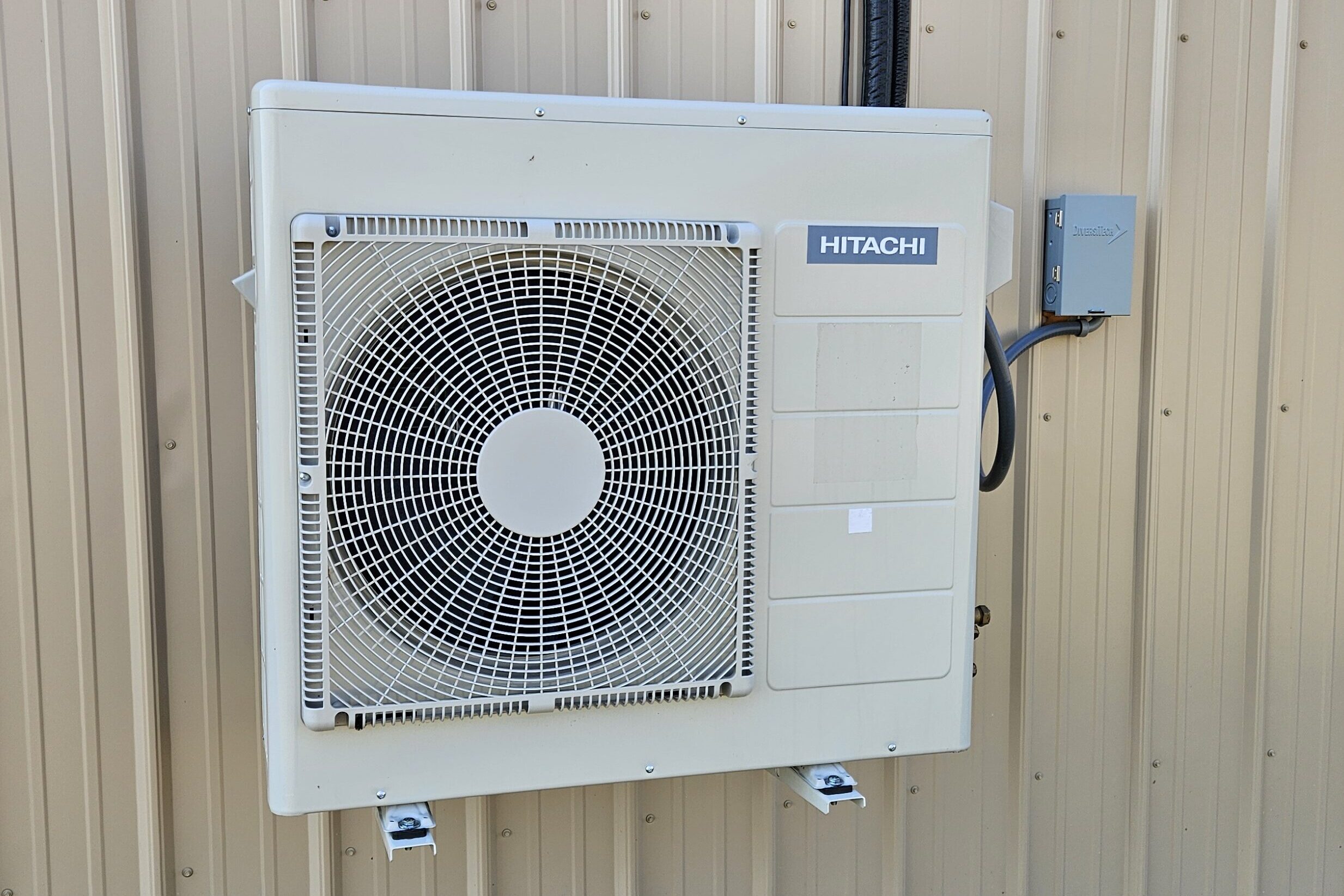 The ductless heat pump outdoor unit is wall mounted, making to easy to mow and maintain around the building.